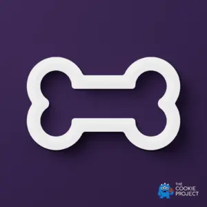 Bone Cookie Cutter - white cutter viewed directly from above on dark purple