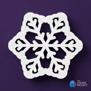 Snowflake Cookie Cutter - white cutter viewed directly from above on dark purple