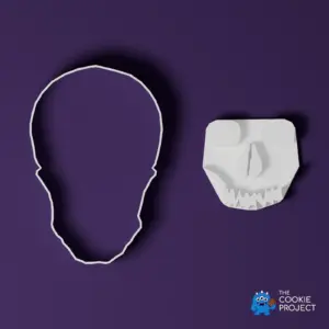 Skull Cookie Cutter and Press Set - complete white tool set viewed directly from above on dark purple