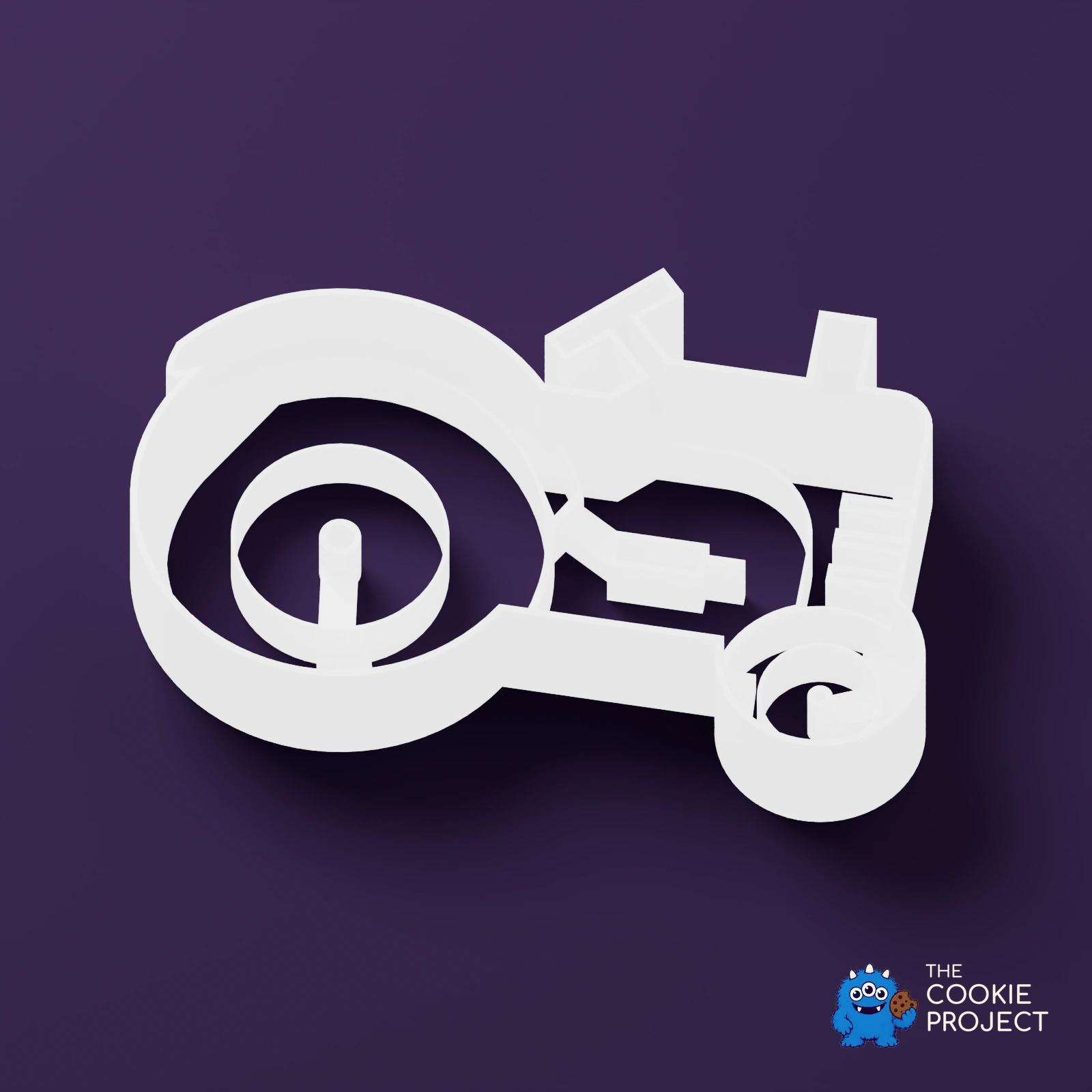Tractor Outline Cookie Cutter - white cutter viewed from an elevated side angle on dark purple