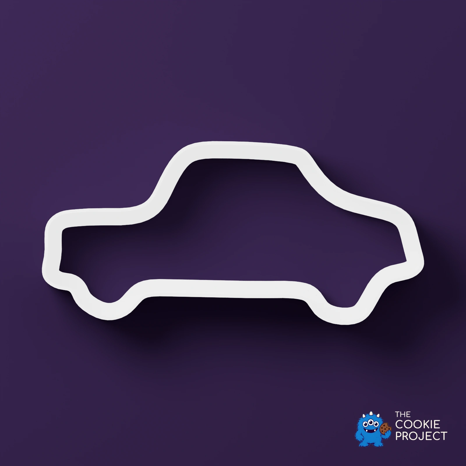Car Outline Cookie Cutter - white cutter viewed directly from above on dark purple