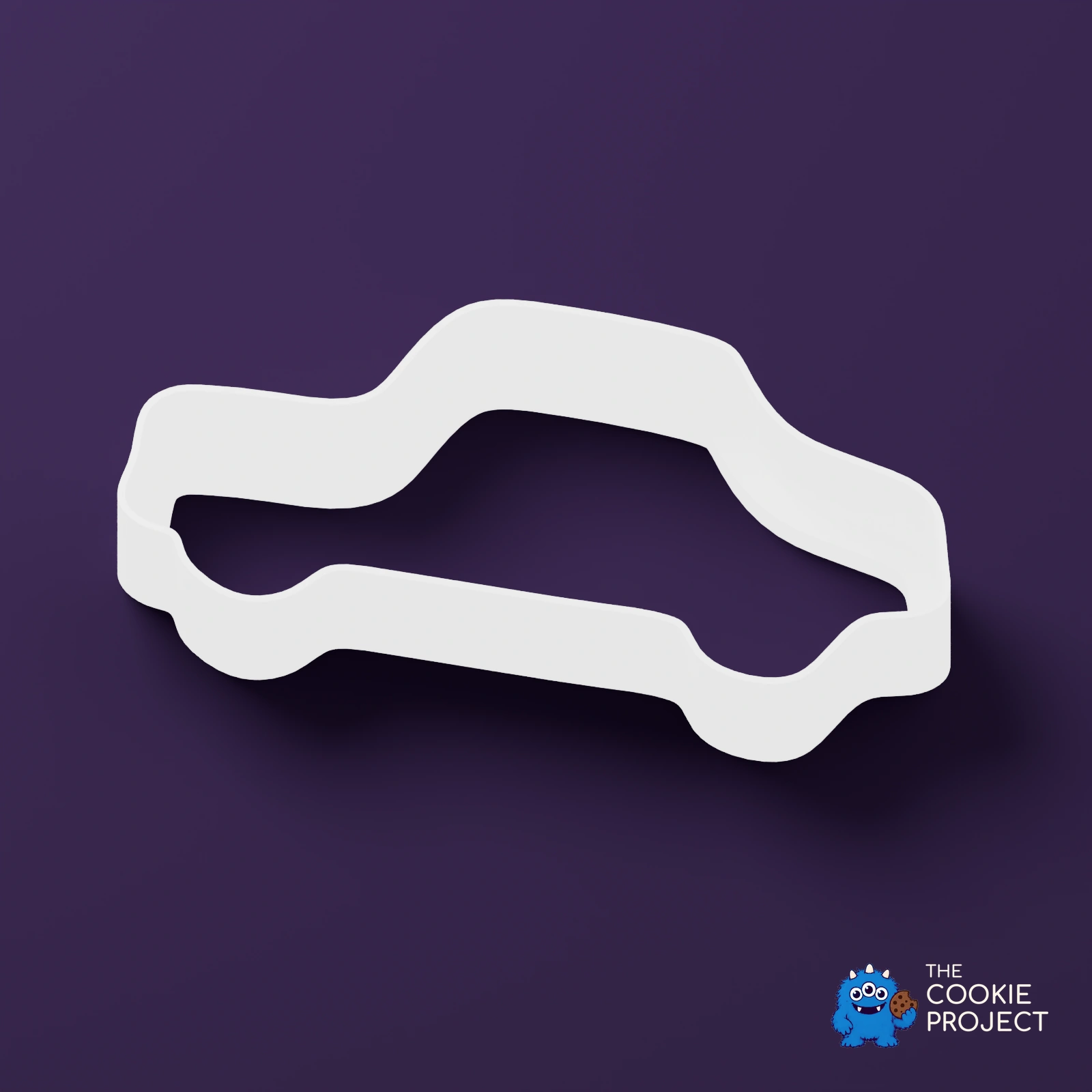 Car Outline Cookie Cutter - white cutter viewed from an elevated side angle on dark purple
