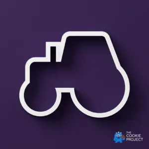 Basic Tractor Cookie Cutter - white cutter viewed directly from above on dark purple