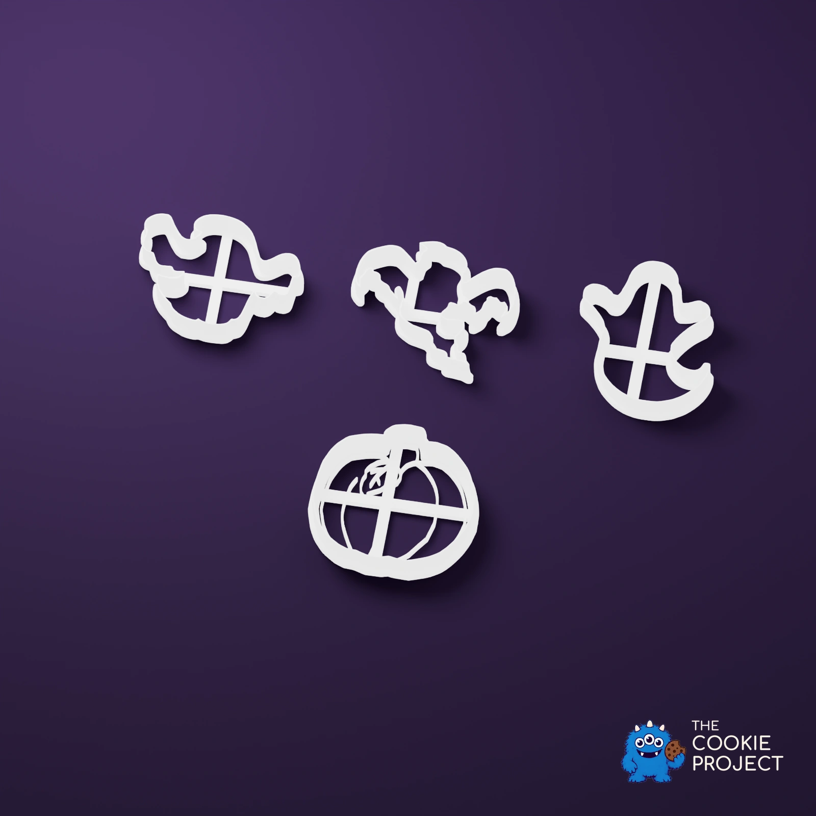 Ghost and Pumpkin Cookie Cutter Set of 4 - bright white complete tools viewed from an elevated side angle on dark purple